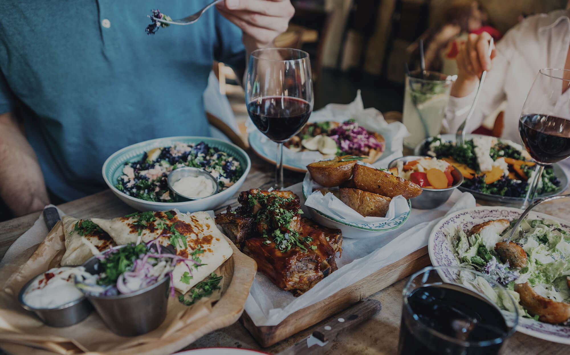 Special occasion meal with multiple dishes and Iron + Sand wines
